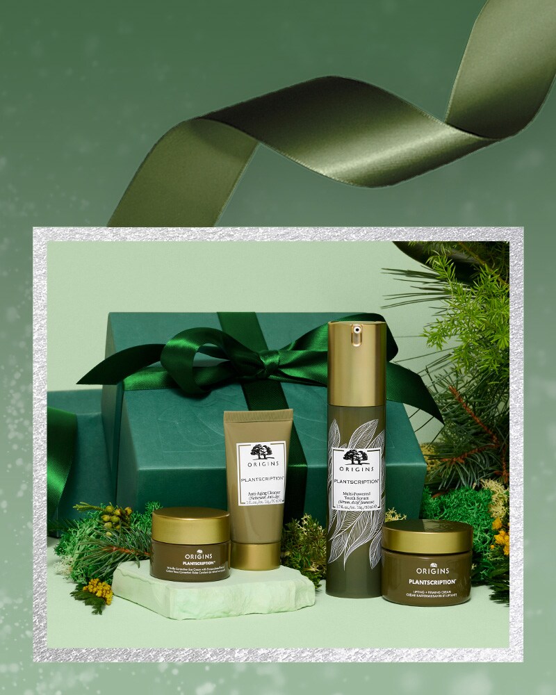 Origins Plantscription holiday set with green festive background