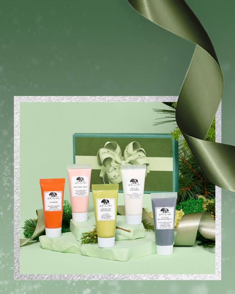 Origins mask holiday set with green festive background